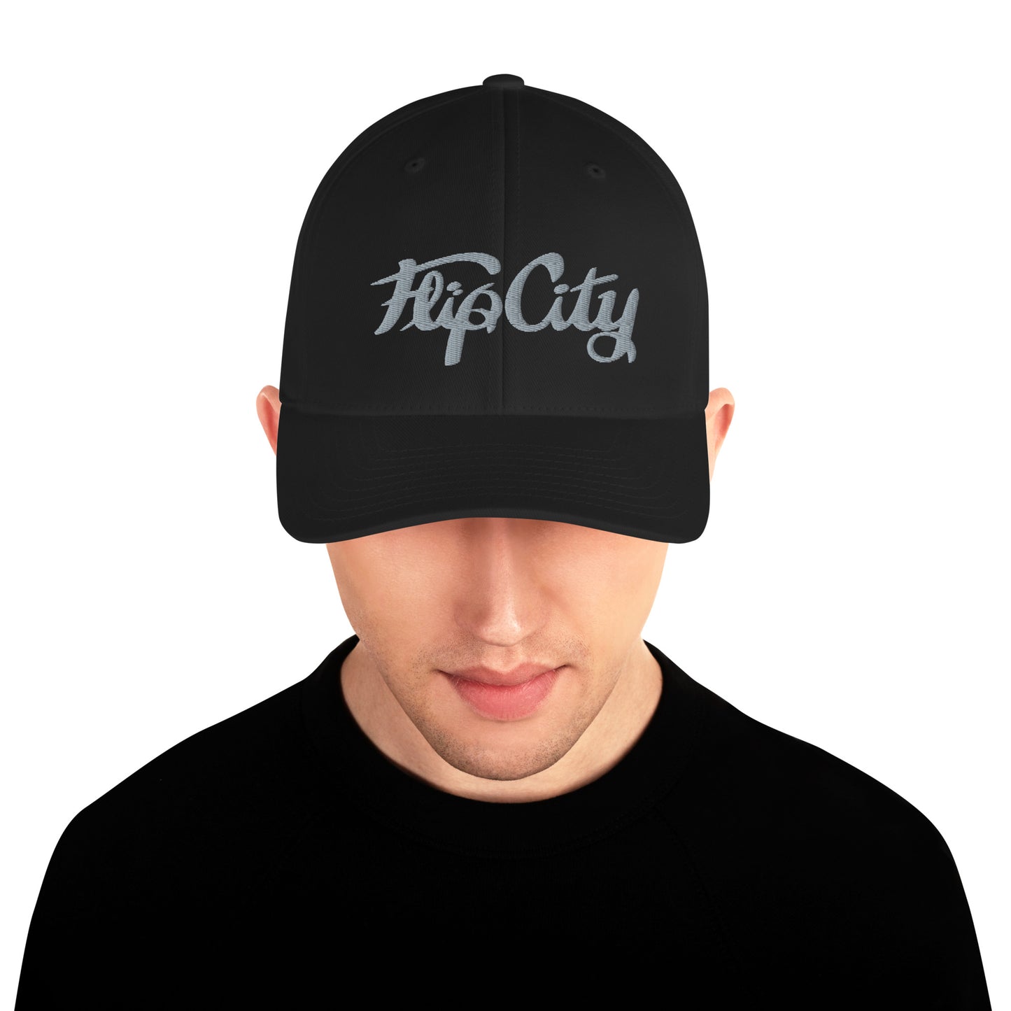 A man wearing a grey black structured twill cap with 'Flip City' stitched on the front