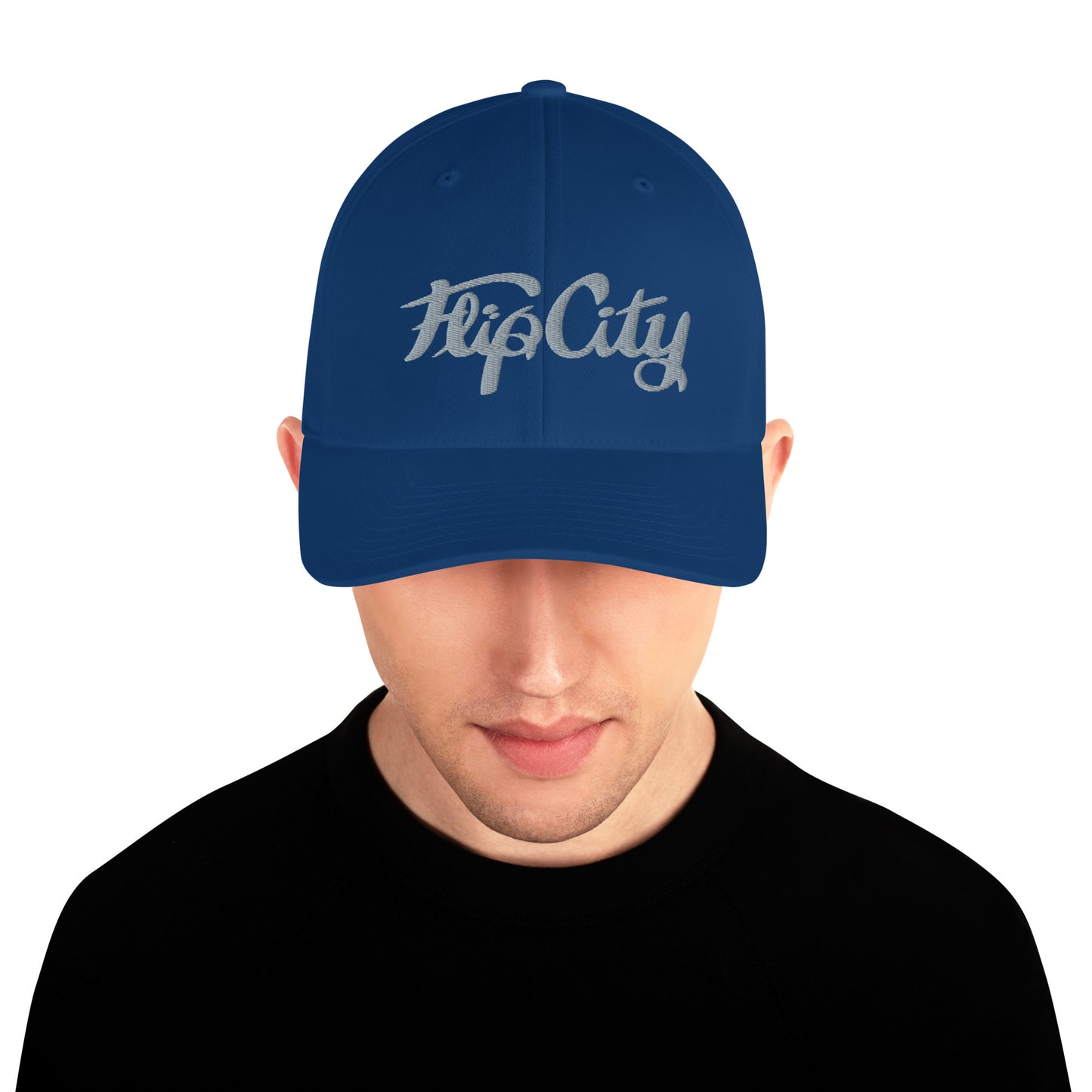 A man wearing a BLUE structured baseball cap with 'Flip City' embroidery on the front.